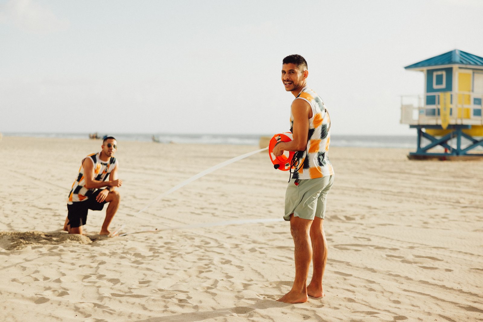 Player resting with gear under the palms