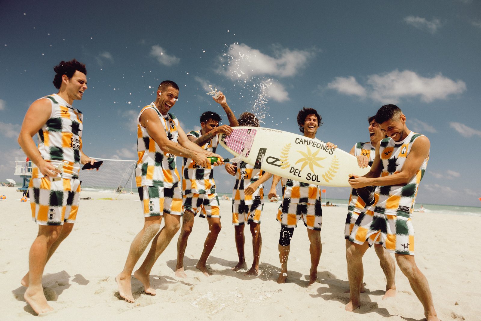 CFPM team celebrating a championship with the Campeones del Sol surfboard